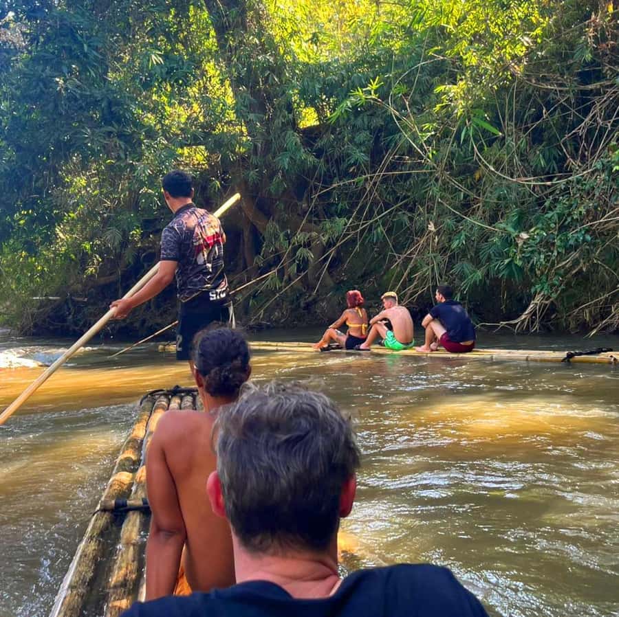 Khao Sok: Private Bamboo Rafting & Jungle Cave Temple Tour - Feeding the fish from the raft